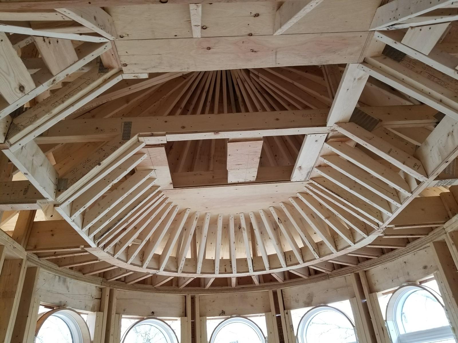 Radial ceiling framing over a curved turret room